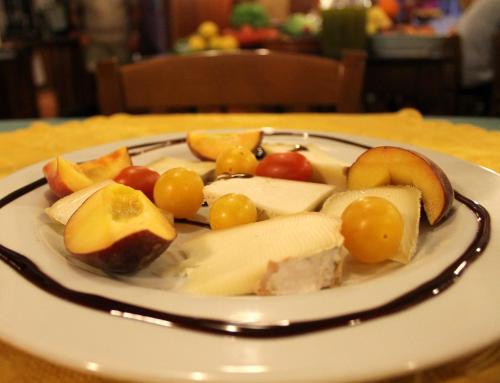 a plate of fruit and vegetables on a table at Albergo Santo Spirito in Molini di Triora