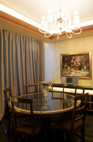 a dining room with a glass table and chairs at Lahoya Beirut in Beirut