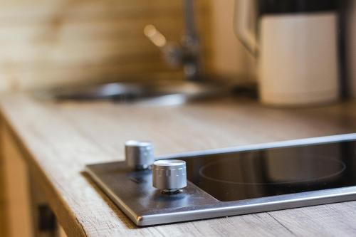 a kitchen counter with a sink and a counter top at Domki na Pieknej in Niechorze