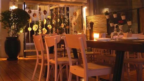a dining room with a wooden table and chairs at Paliria Hotel in Chalkida