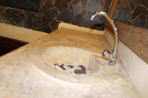 a bathroom with a sink with a faucet at Puri Kutat Lestari in Sanur