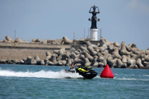 a person on a jet ski in the water at Studios Grace - Port Tsarevo in Tsarevo