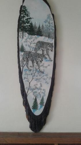 a mirror hanging on a wall with wolves in the snow at Hostel Mnogoborets F. Klub in Odesa