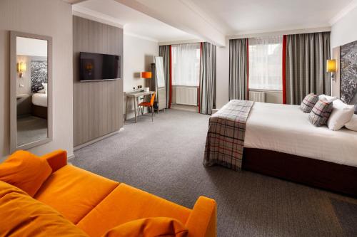 a hotel room with a bed and a couch at Mercure Inverness Hotel in Inverness