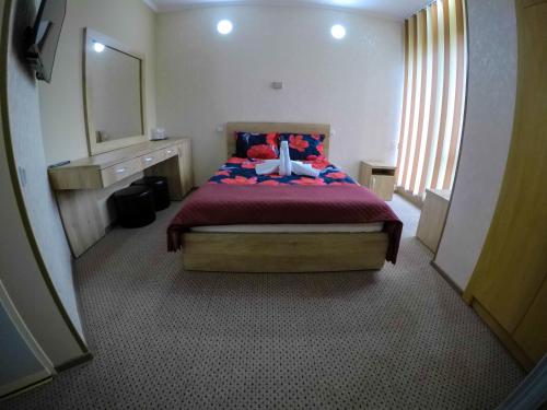 a bedroom with a bed with a cross on it at Motel Carmen in Baia Mare