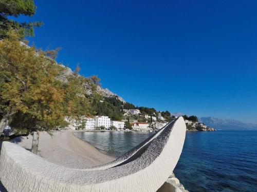 a hammock on a beach next to the water at Apartments Mirko in Mimice
