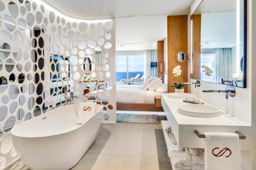 a bath room with a tub and a sink at Royal Hideaway Corales Beach - Adults Only, by Barceló Hotel Group in Adeje