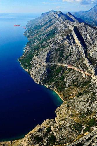 an aerial view of a mountain with blue water at Apartments Mirko in Mimice