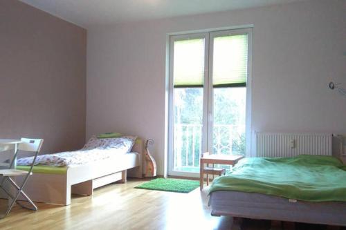 a bedroom with a bed and a large window at Apartament Monika in Sopot