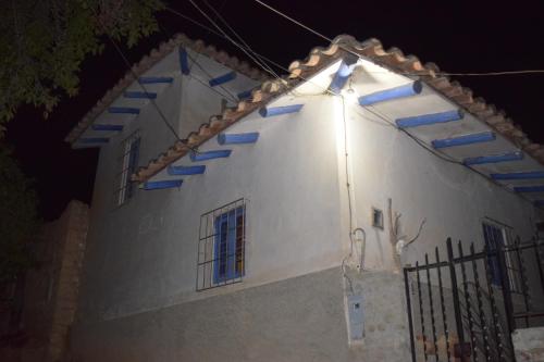 a white house with blue stairs on the side of it at La Casita de mi Abuela in Mancos