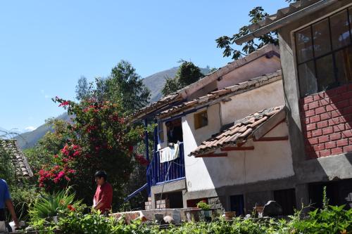 a person standing on a balcony of a house at La Casita de mi Abuela in Mancos