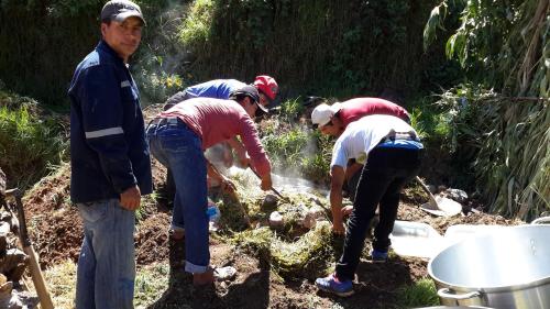 a group of people standing in the dirt at La Casita de mi Abuela in Mancos