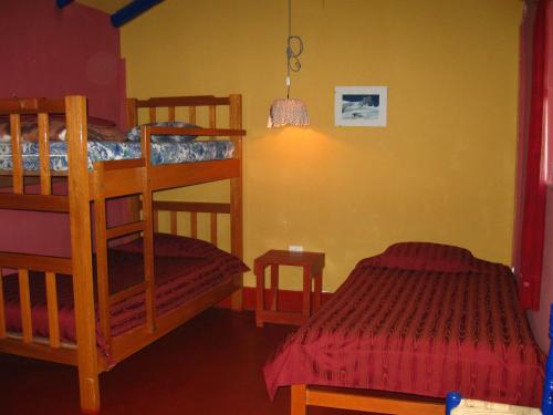 a bedroom with two bunk beds and a bed at La Casita de mi Abuela in Mancos