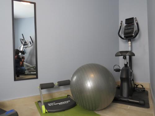 a gym with a exercise ball and a treadmill at Rest Inn in Terrace