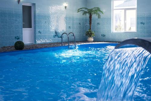 a swimming pool with a water slide in a house at Family Complex Zastava u Oki in Velegozh