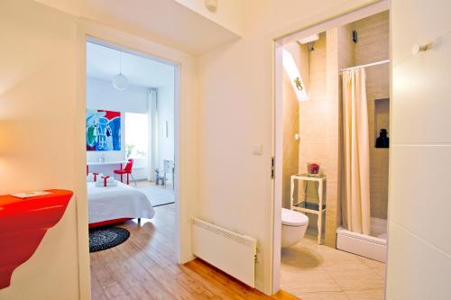 a bathroom with a toilet and a room with a bedroom at Rooms Zagreb 17 in Zagreb