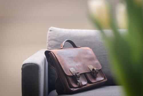 a brown briefcase sitting on a couch at B&B Antares in Bruges