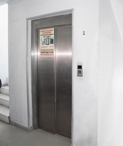 a metal elevator in a building with a sign on it at Apartment near the Black Sea Ureki in Ureki