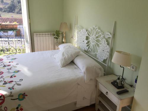 a bedroom with a white bed and a window at Villa Elena in Potes