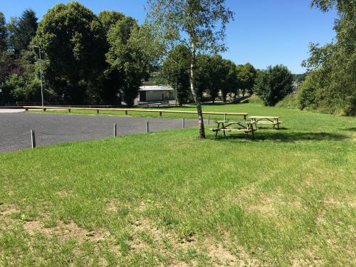 a picnic table in the grass near a road at B&B Pommerloch in Pommerloch