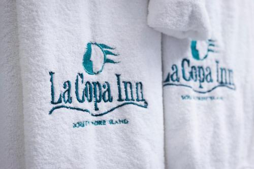 a close up of two white t shirts with handwriting at La Copa Inn Beach Hotel in South Padre Island