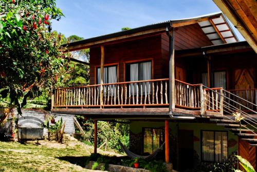a house with a balcony on the side of it at Pension Santa Elena in Monteverde Costa Rica