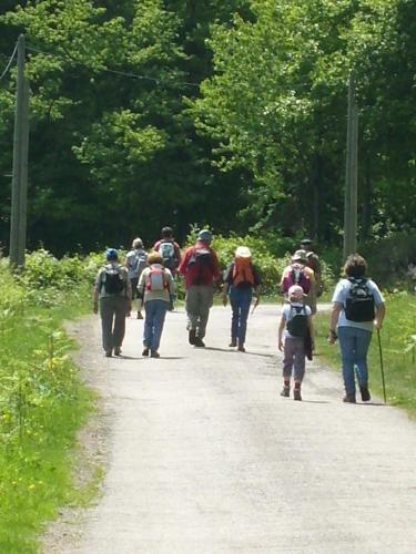 a group of people walking down a dirt road at Chalet du Montal in Dun-les-Places