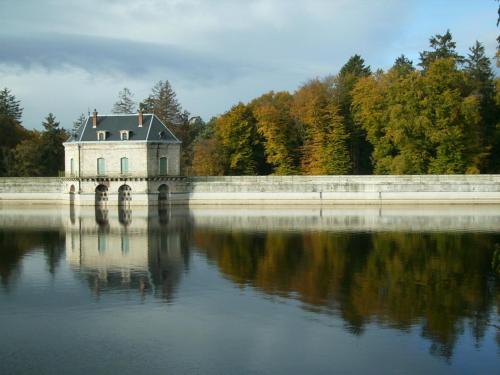 a house on a bridge over a body of water at Chalet du Montal in Dun-les-Places