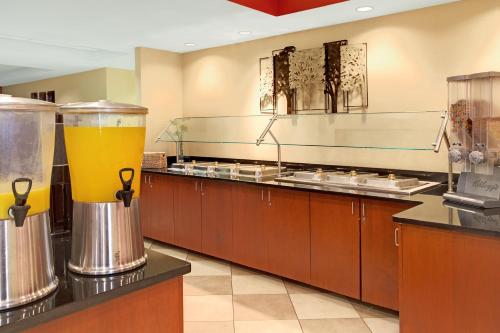 a kitchen with a counter with a large glass of beer at Wyndham Garden Duluth in Duluth