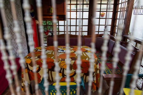 a table and chairs in a room with windows at Deiada Guest House in Alba Iulia