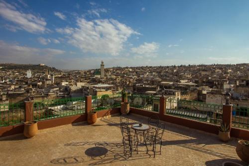 a balcony with a view of a city at Riad Al Fassia Palace in Fès