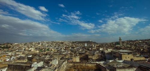 a view of a city with buildings and a tower at Riad Al Fassia Palace in Fès