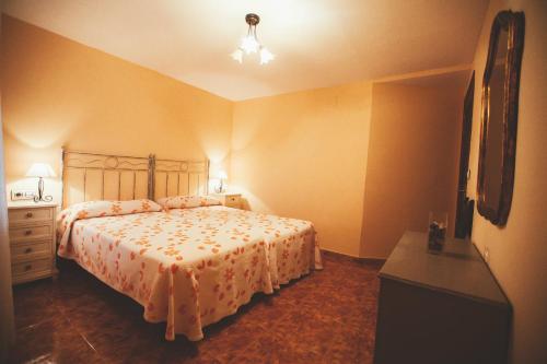 a bedroom with a bed and a dresser and a television at El Requexu, apartamentos a 900 m de la playa de Poo AR-0474-AS in Llanes