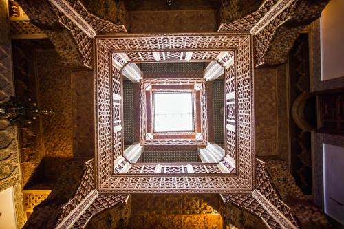 an ornate staircase in a building with a window at Riad Al Fassia Palace in Fès