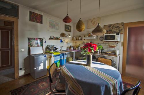 a kitchen with a table with a vase of flowers on it at Libertyroofgarden in Bassano del Grappa