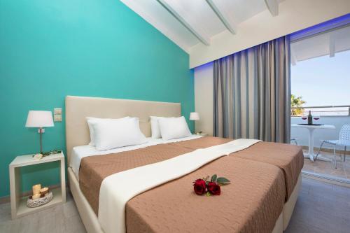 a bedroom with a large bed with flowers on it at Onar Corfu Aparts & Studios in Ýpsos