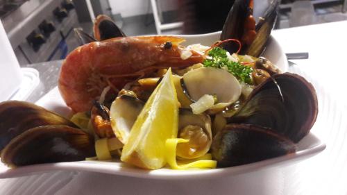 a plate of food with a lobster and other foods at Hotel De La Mer in Le Barcarès
