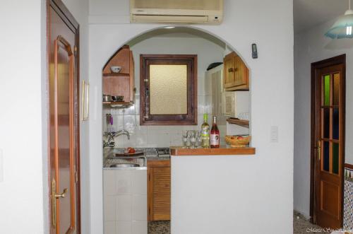 a kitchen with an archway in the middle of a room at Castillo del Mar in Almuñécar