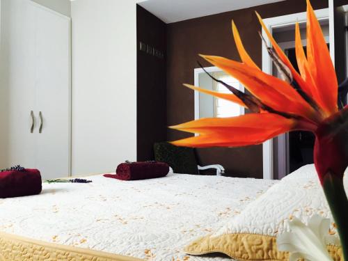 a bedroom with a large orange flower on a bed at Lo Raconet in Deltebre