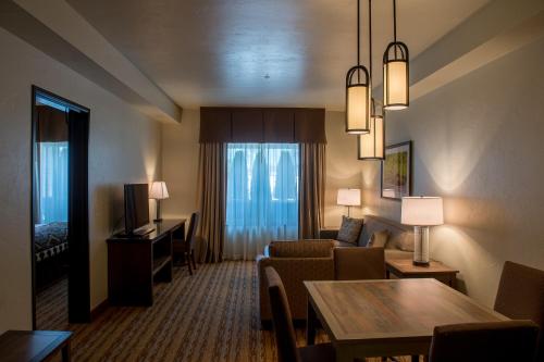 a hotel room with a couch and a living room at Cedar Creek Lodge & Conference Center in Columbia Falls