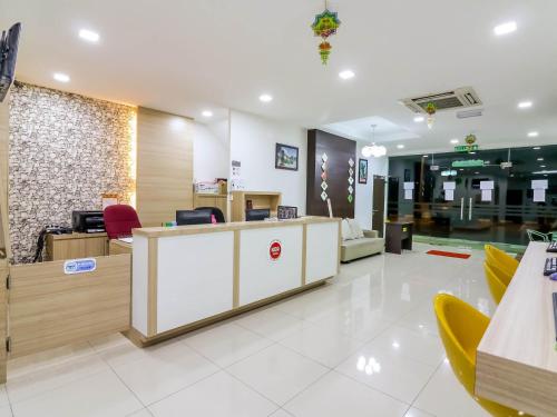 a lobby of a hospital with a reception desk and chairs at D' ART GALLERY HOTEL in Seri Iskandar