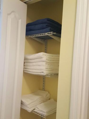 a closet filled with lots of white towels at Charming Kendall Home in Kendall