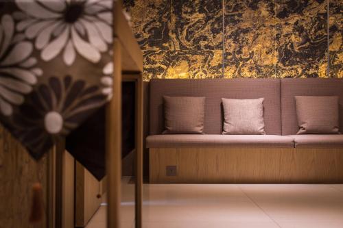 a couch with two pillows on it in a room at Green World Taipei Station in Taipei
