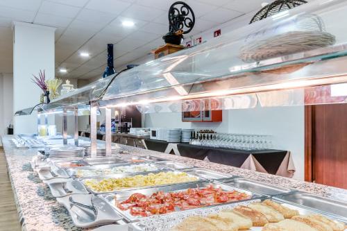 a buffet line with many trays of food at Hotel Gran Playa in Santa Pola