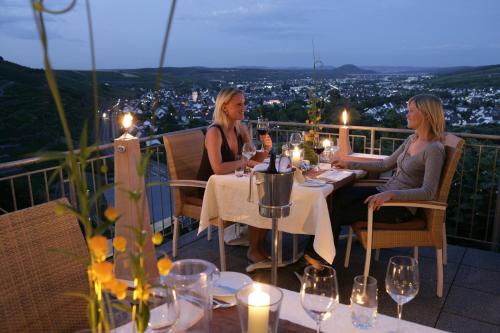 two women sitting at a table with wine glasses at Hohenzollern in Bad Neuenahr-Ahrweiler