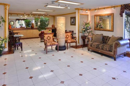 a lobby with couches and chairs and a table at Americas Best Value Inn & Suites - Fontana in Fontana
