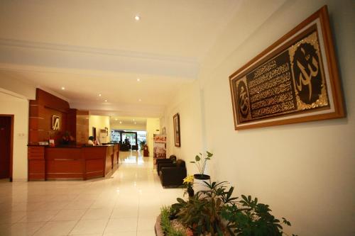 a lobby of a hospital with a picture on the wall at Syariah Arini Hotel in Solo