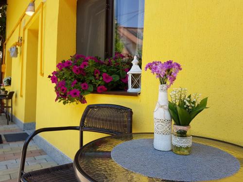 Una mesa con dos jarrones y flores. en House Apartment Minerilor, en Cluj-Napoca