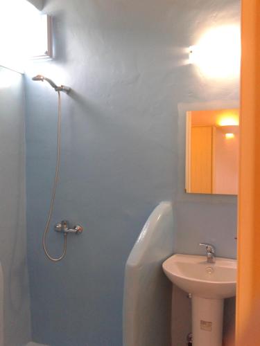 a bathroom with a bath tub and a sink at Ammos Studio in Koufonisia
