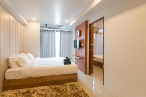 a bedroom with a large bed and a mirror at 2 Feel Bed Station in Udon Thani